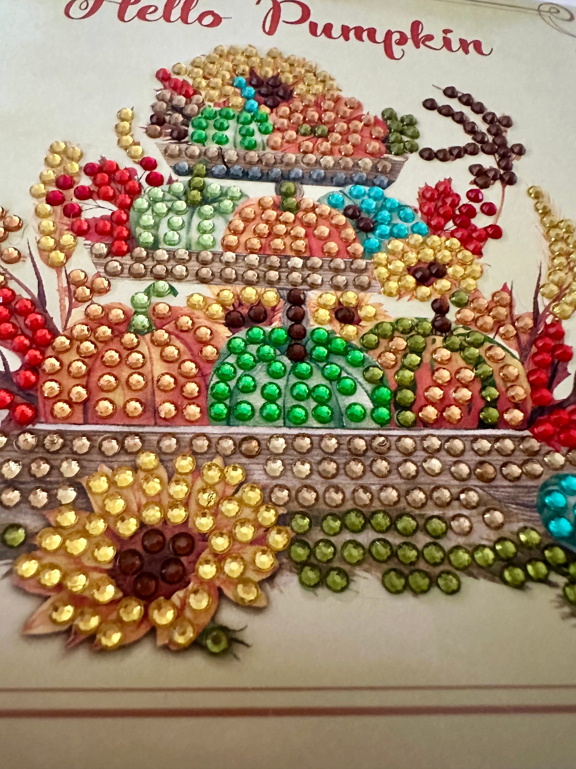 Decorative card with colorful diamond dots and 'Hello Pumpkin' text on a beige background