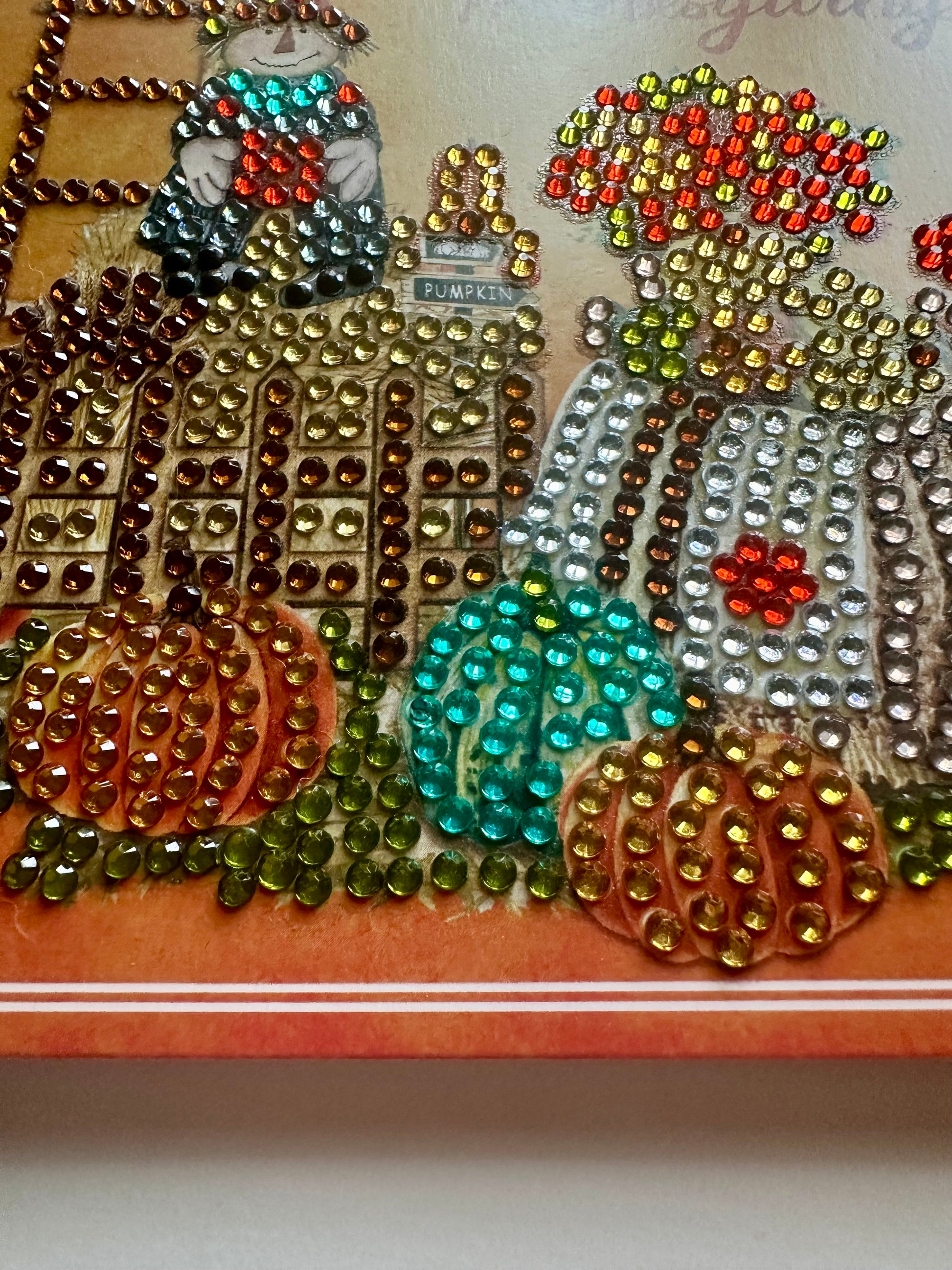 Handmade 6x6 greeting card with diamond dots forming pumpkins and a scarecrow figure on an orange background.