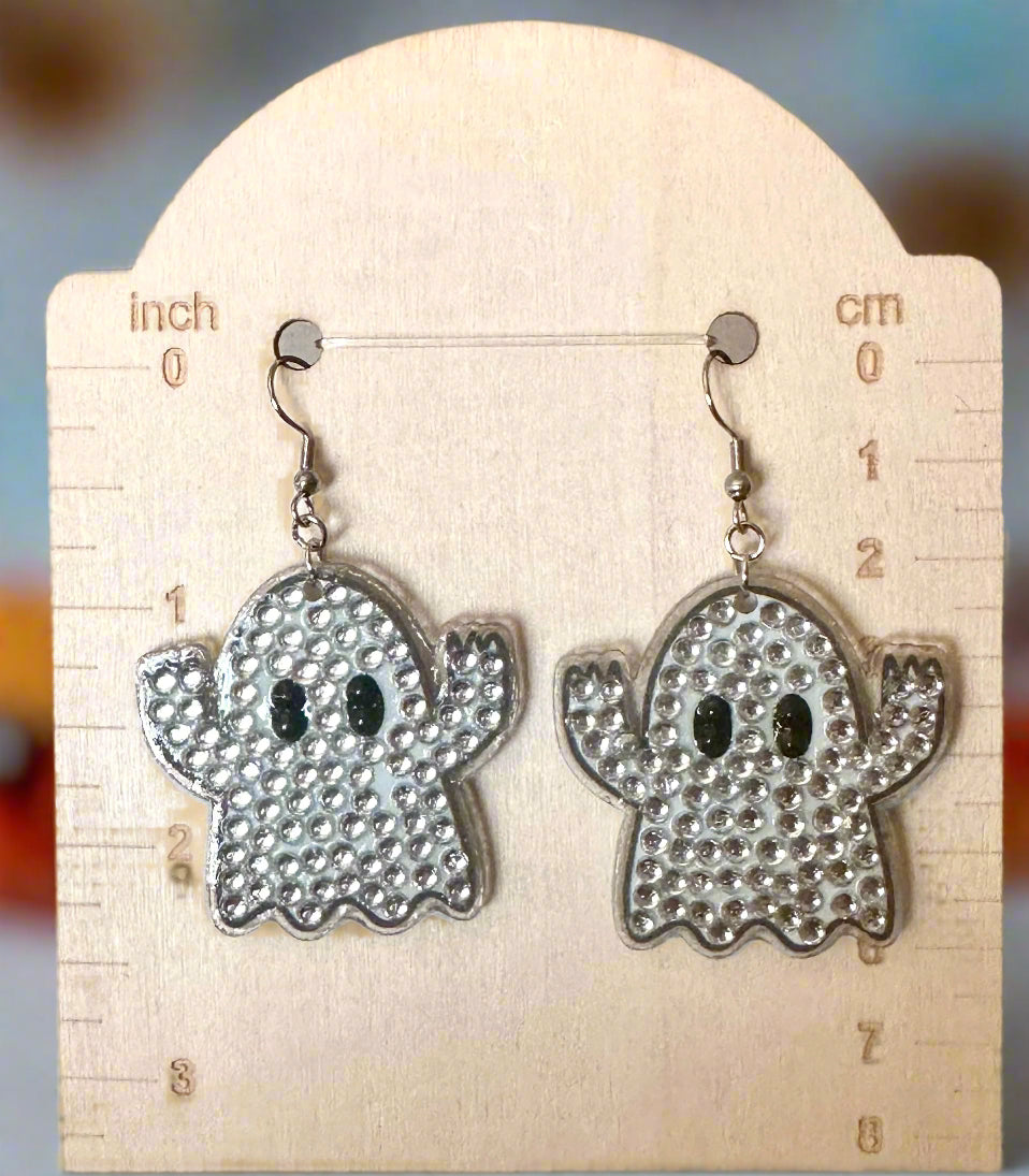 Ghost-shaped earrings with rhinestones on a card with measurements