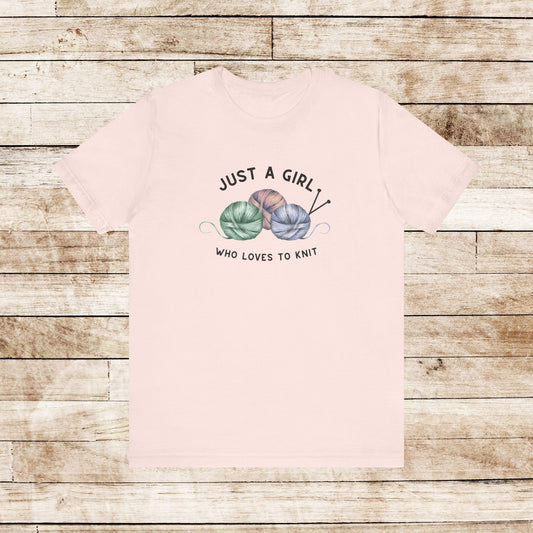 Funny Knitting T-Shirt- Just a Girl Who Loves to Knit, soft pink color shirt with black letters, 3 balls of yarn with knitting needles