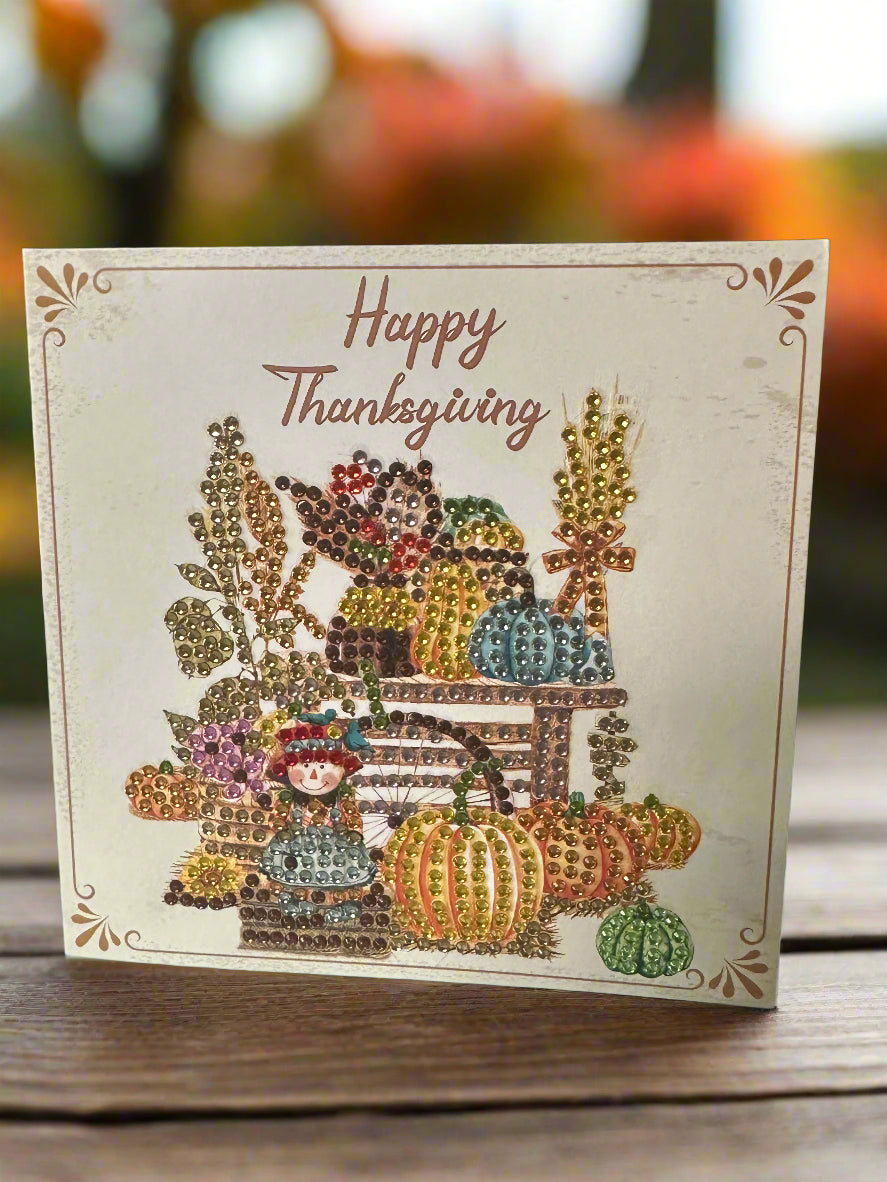 Decorative Thanksgiving card with colorful pumpkins and a scarecrow figure on a wooden surface.