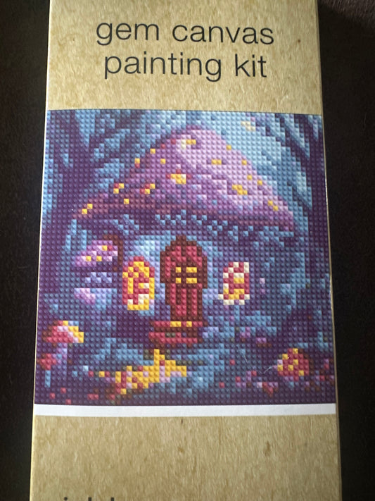 Gem canvas painting kit with a colorful mushroom house on a cardboard backing