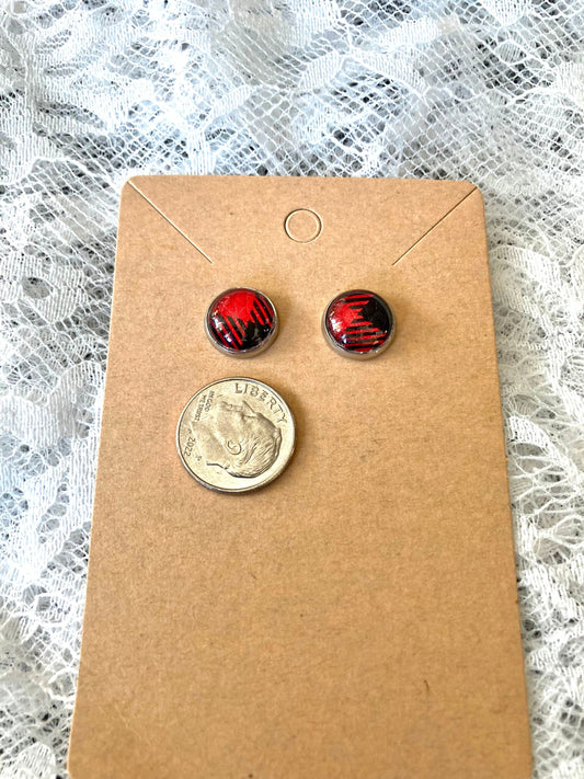 round stud earrings with red and black buffalo plaid faux leather center with dime to show size