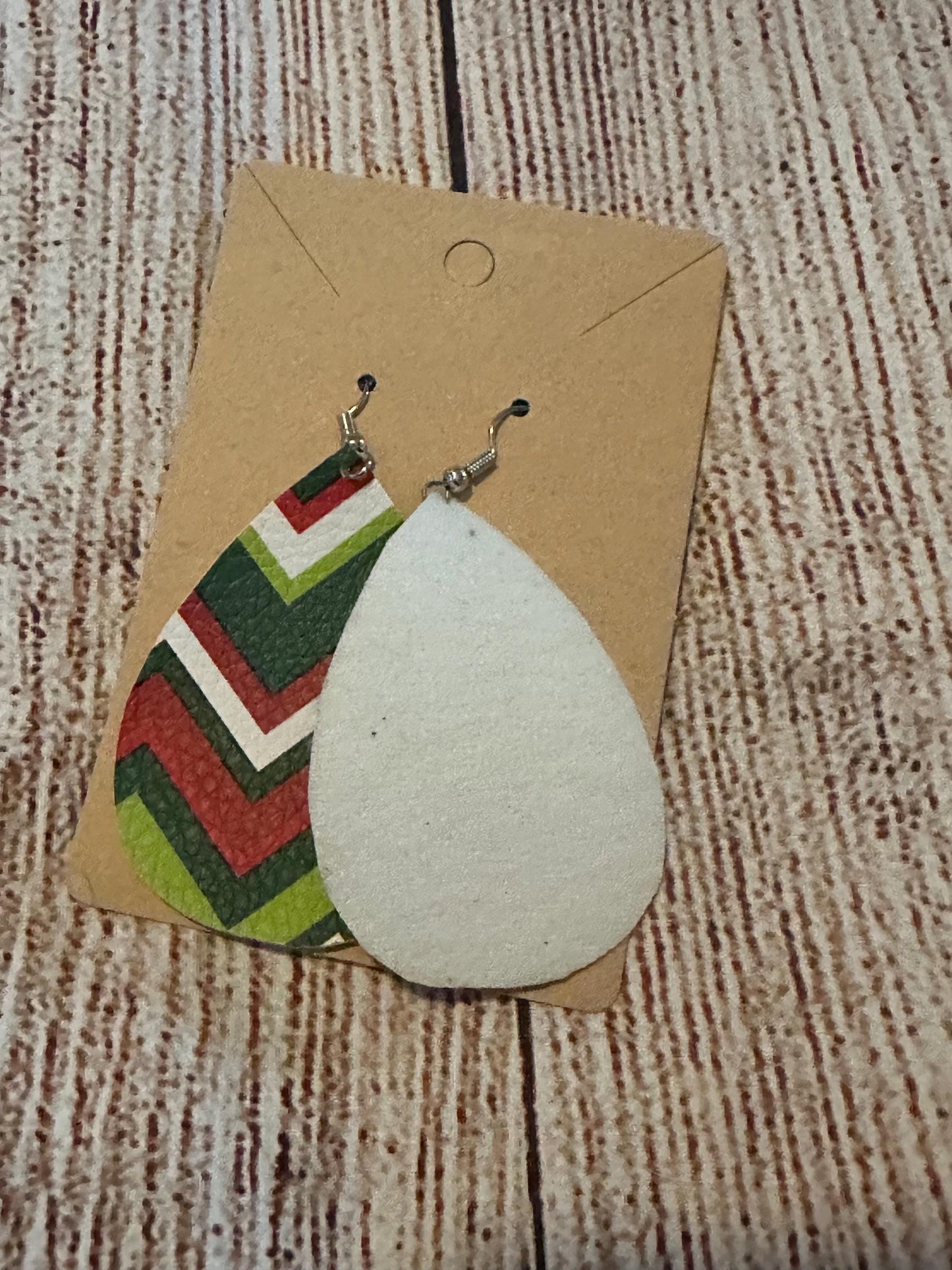 Red, Green, White Chevron Faux Leather Teardrop Earrings with fish hooks showing front of one earring and white back of the other