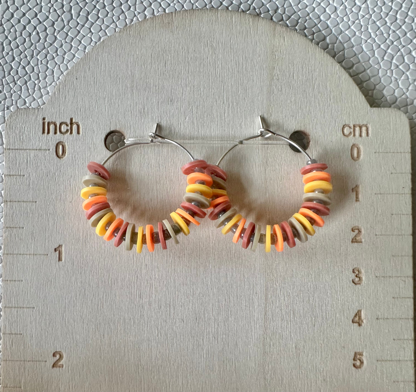 Fall Heishi Bead Hoop Earrings – Autumn Colors – Lightweight 1" Hoops on a measurement card with inches and centimeters.