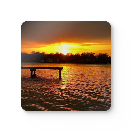 Sunset over water with a dock, creating a serene and picturesque scene on a coaster