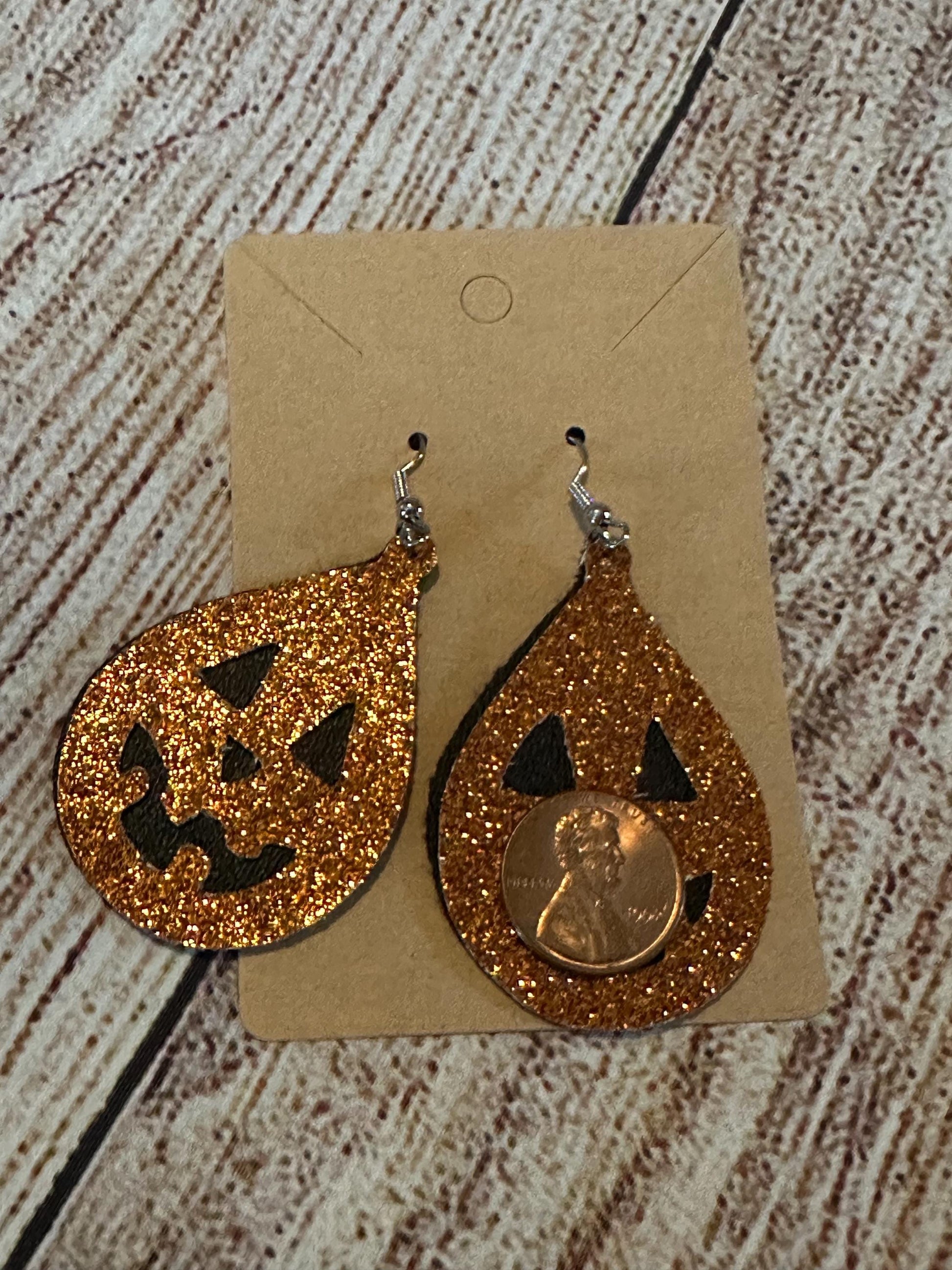 Jack-o-lantern Faux Leather Teardrop Earrings double layer- black under layer with sparkly orange jack o lantern overlay with penny for size
