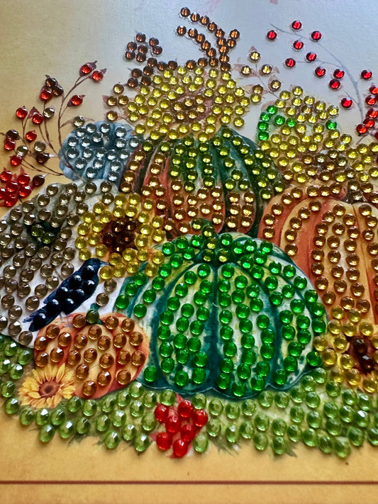 Decorative diamond dot card made featuring pumpkins of different colors and fall foliage.