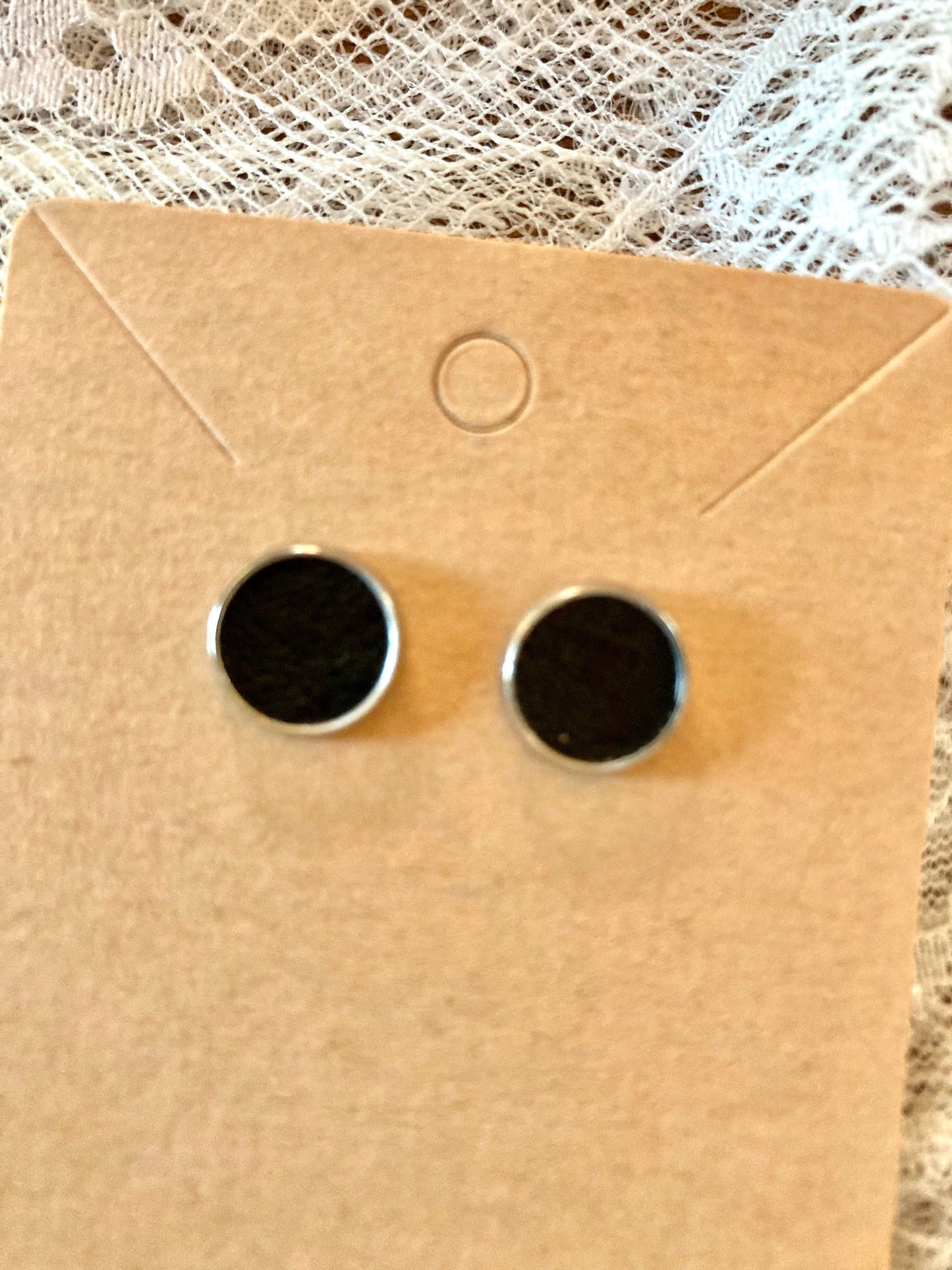 round stud earrings with black faux leather center