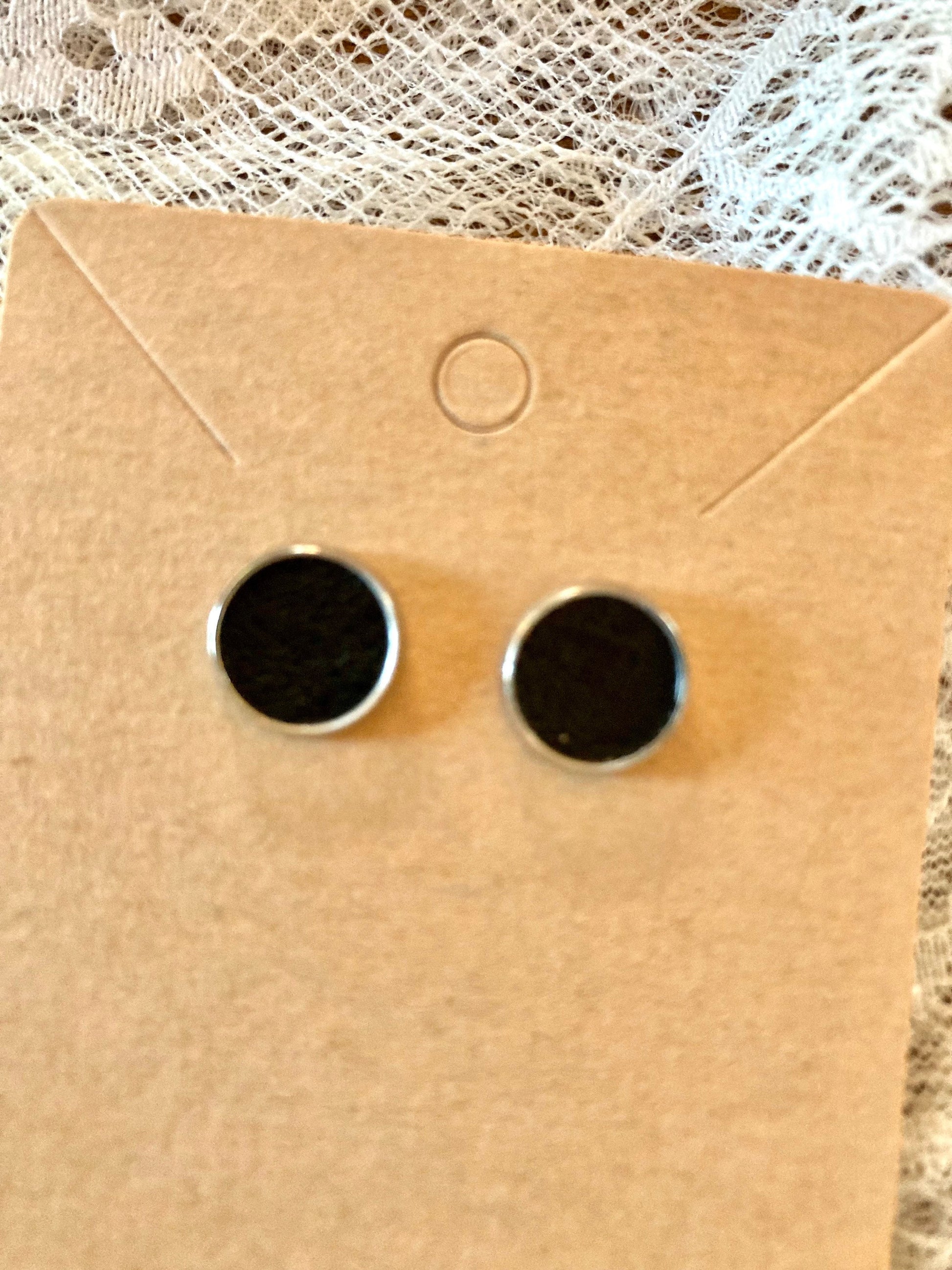 round stud earrings with black faux leather center
