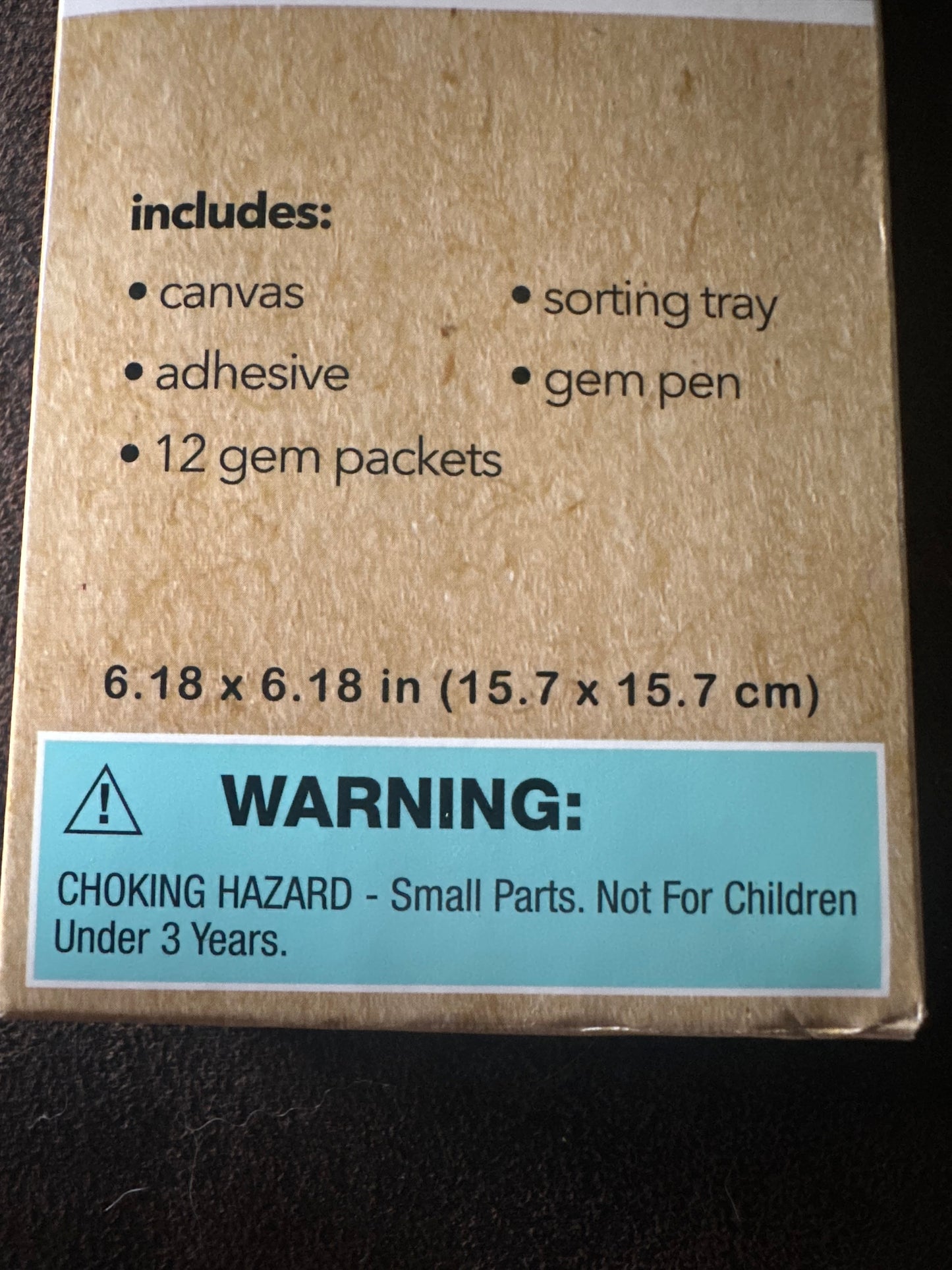 Cardboard box with product details and warning label on a dark background