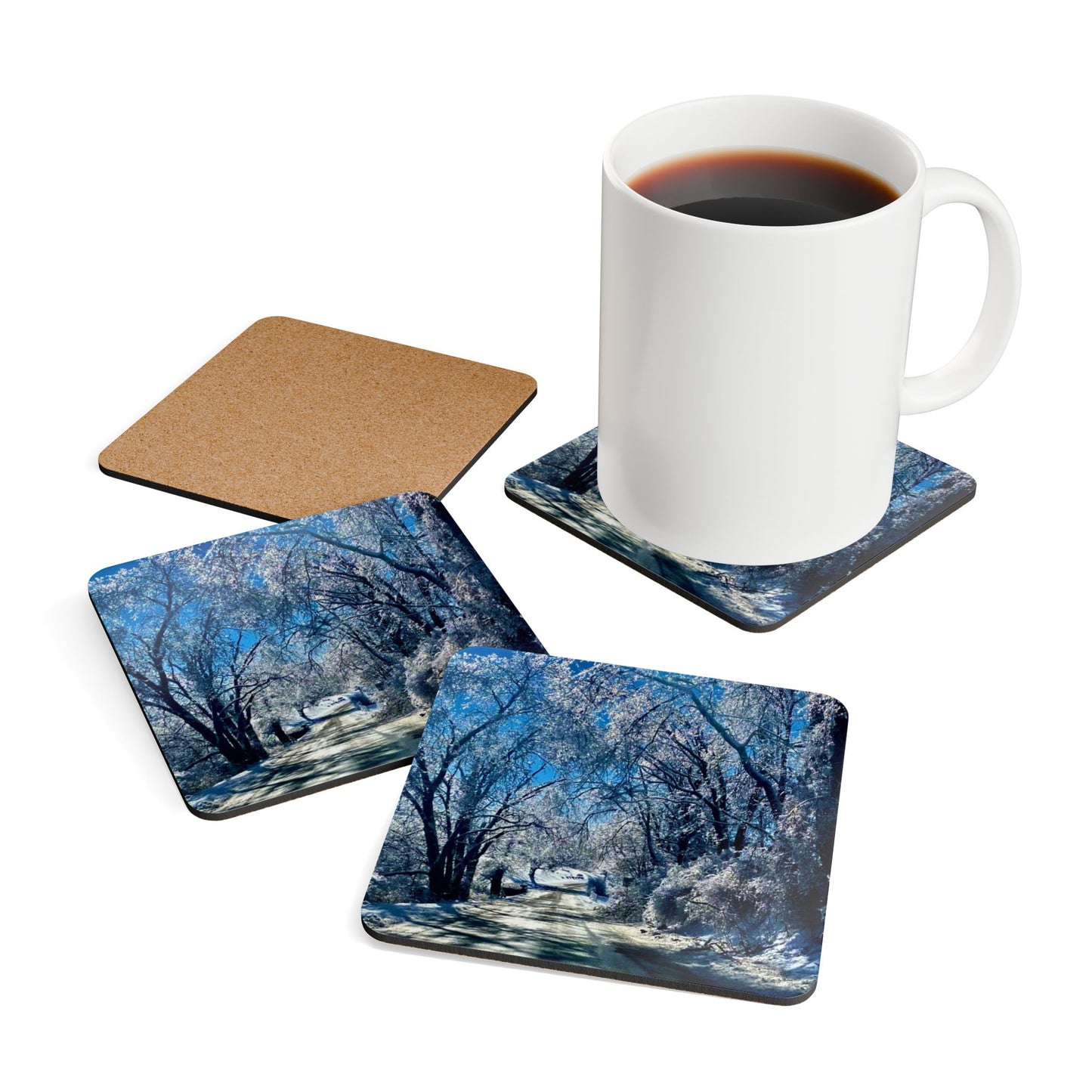 Winter Woodland Road Coasters set of 4 with mug on one coaster, one coaster is upside down showing cork backing