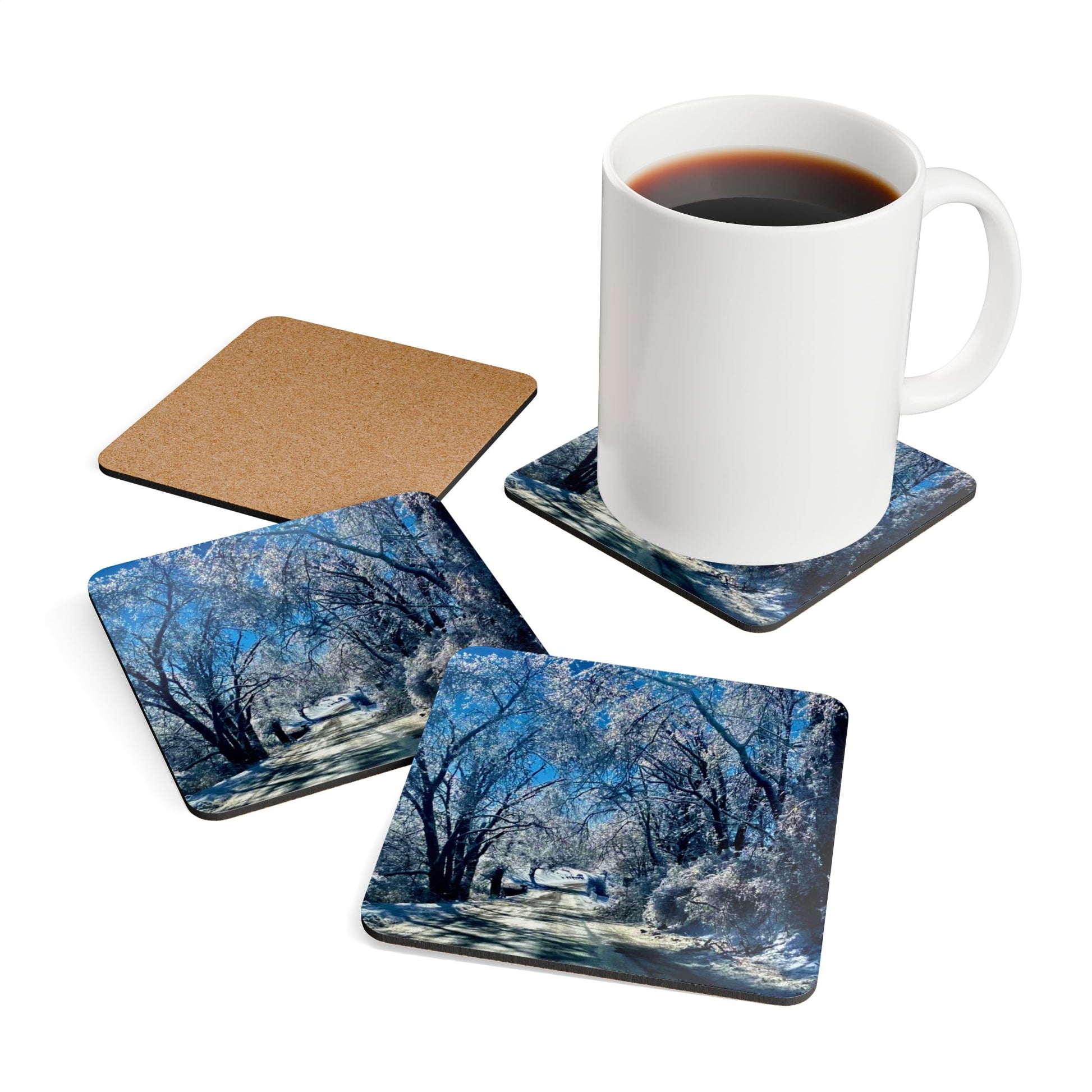 Winter Woodland Road Coasters set of 4 with mug on one coaster, one coaster is upside down showing cork backing