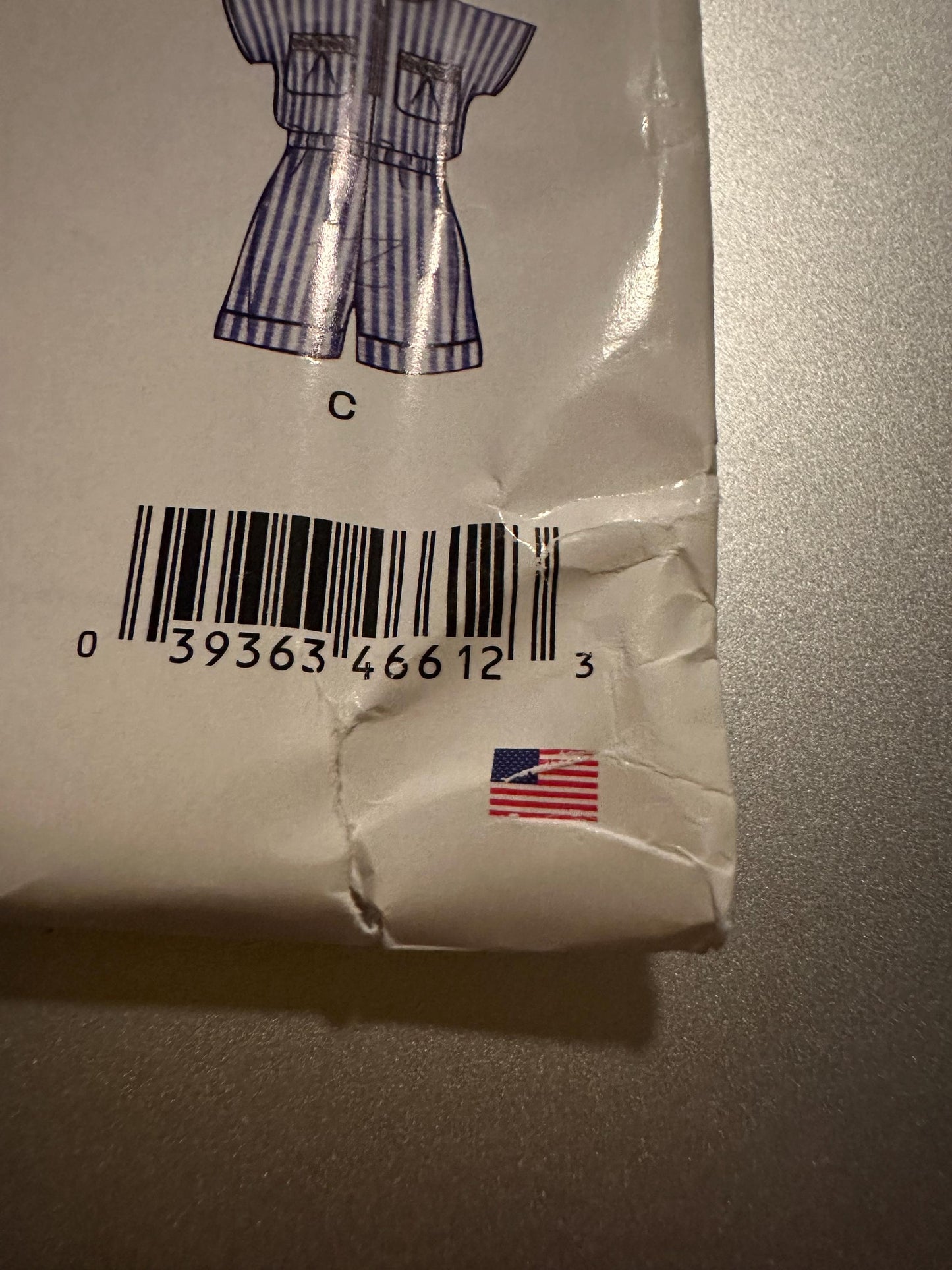 Product packaging with a barcode and American flag label on a gray surface