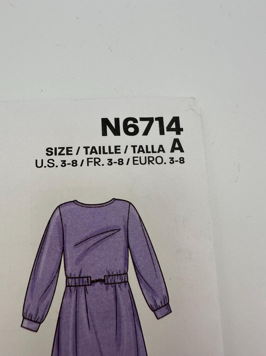 Purple dress with size label N6714 on a light gray background