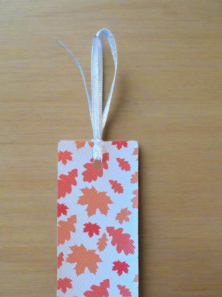 Bookmark with leaf pattern on a wooden surface