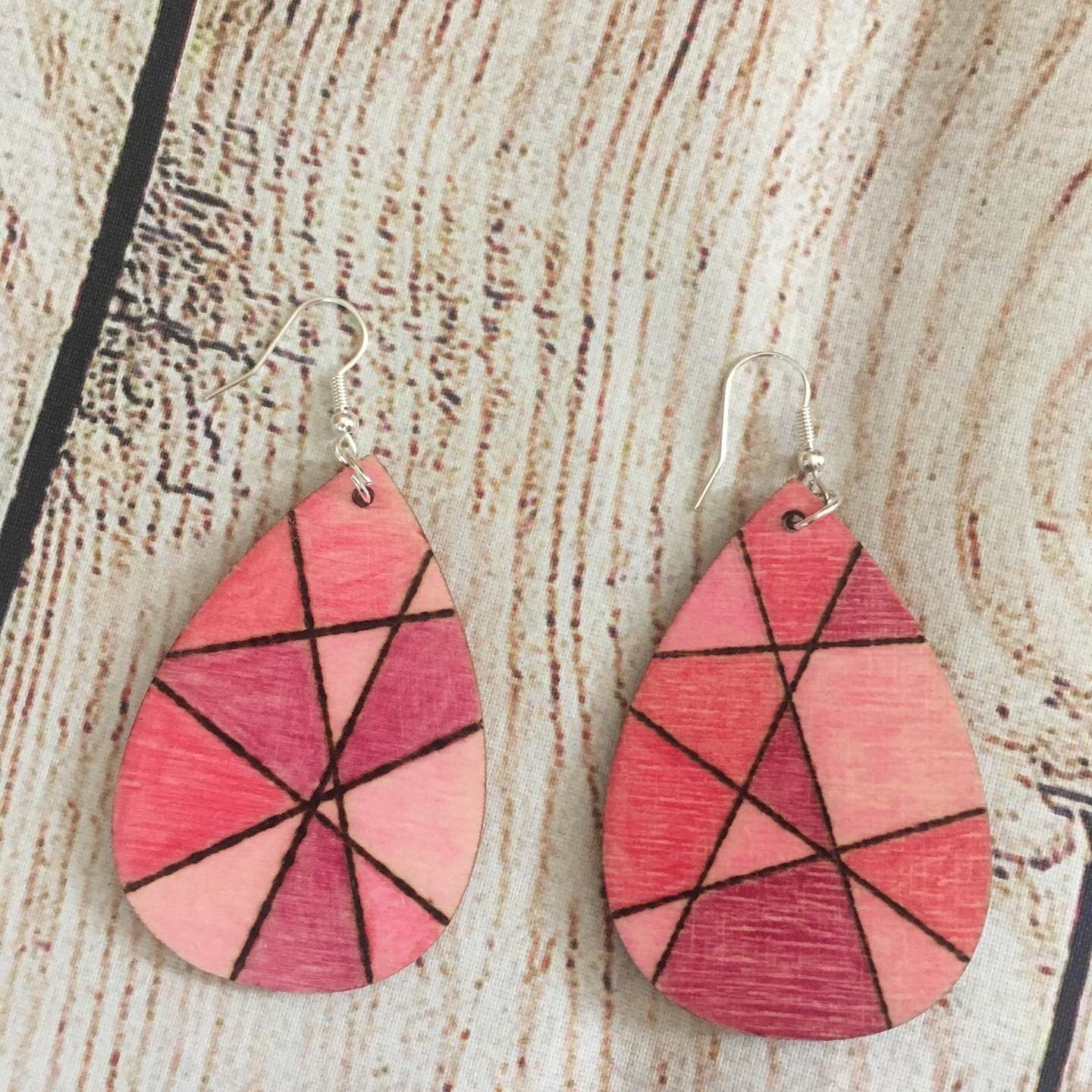 Wood burned earrings with fishhook, teardrop shape, geometric pattern with shade of pink 