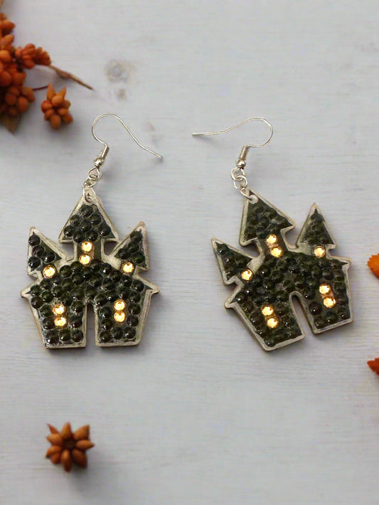 Halloween-themed castle earrings on a light gray background