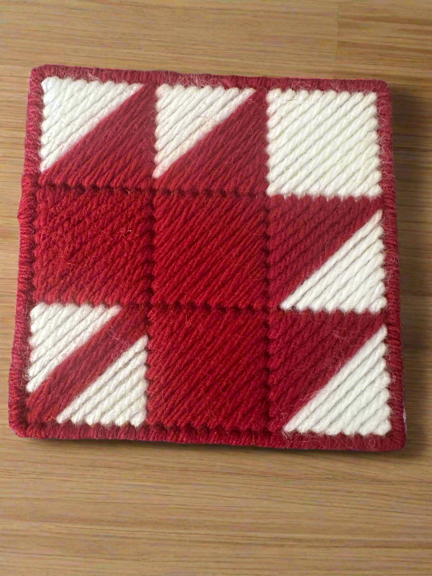red maple leaf coaster with white background and red trim