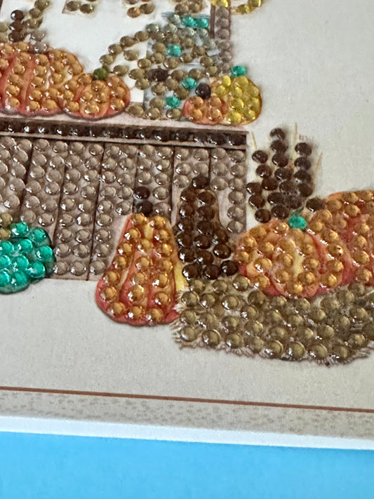 Close-up of a diamond dot artwork depicting pumpkins and gourds on a tan background.