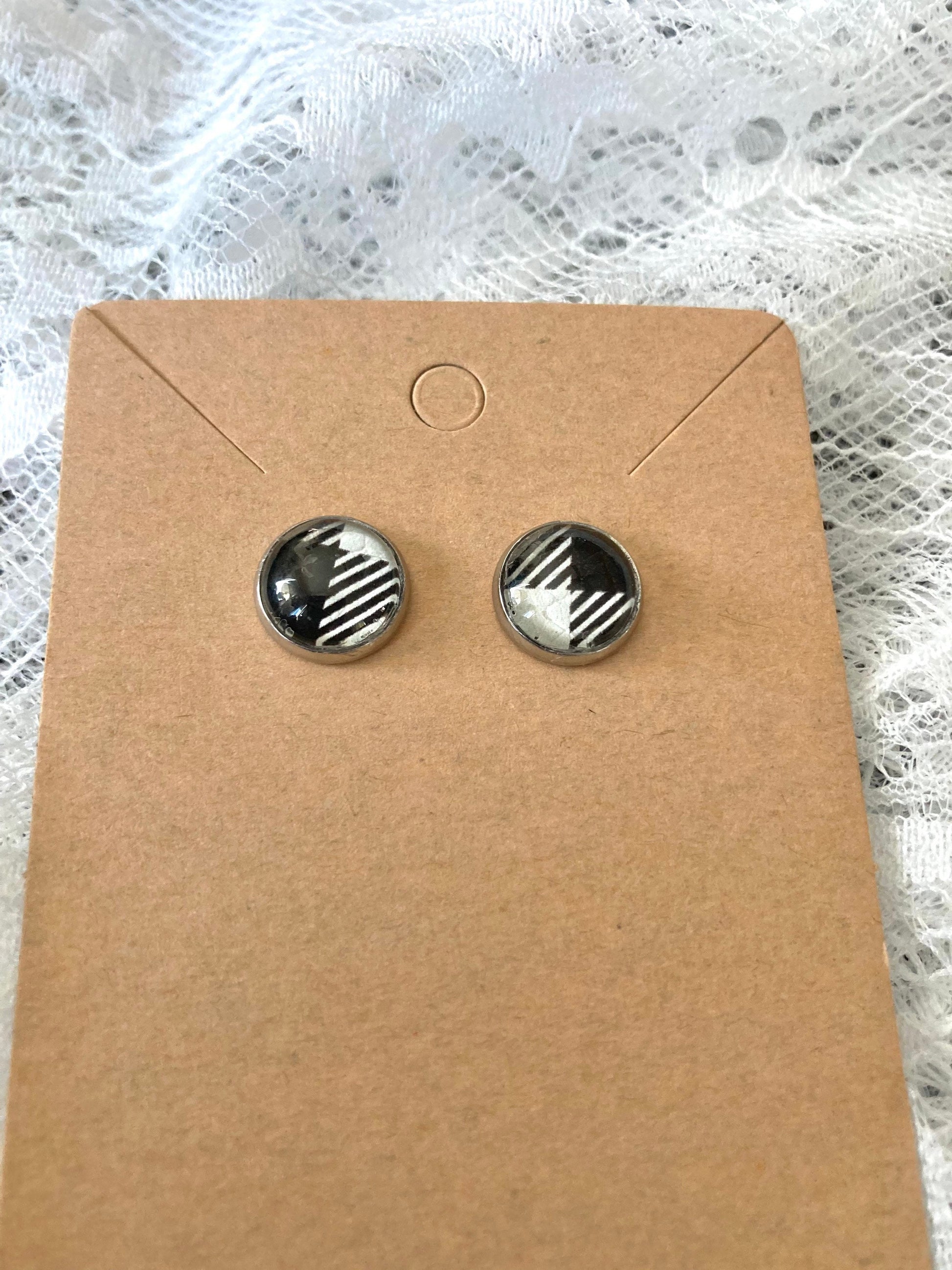 round stud earrings with a black and white buffalo plaid faux leather center
