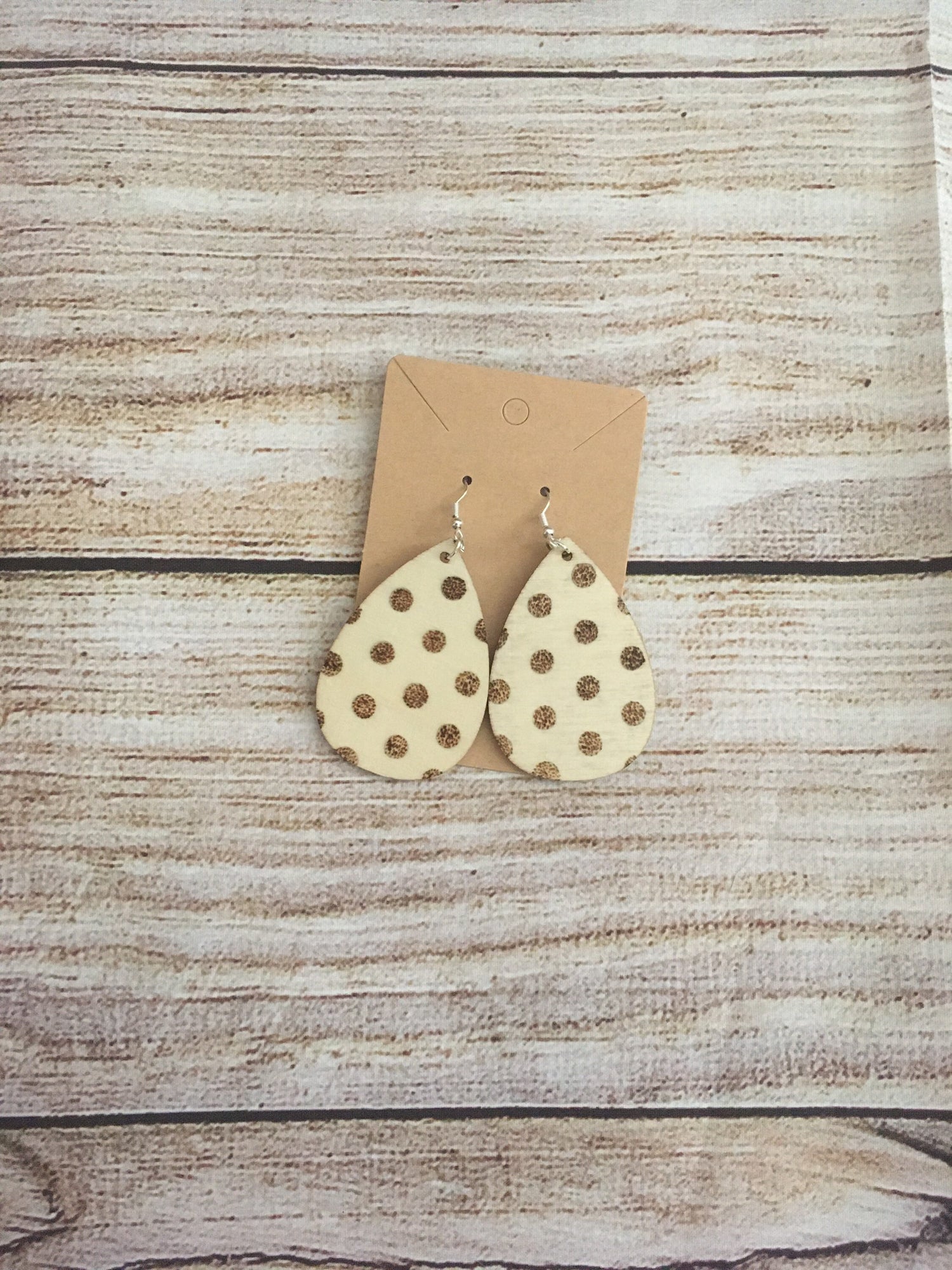 Wood burned earring with polka dot pattern. Earrings are tear drop shaped with fishhooks